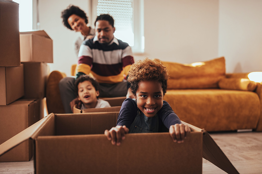 Happy kids playing in moving boxes