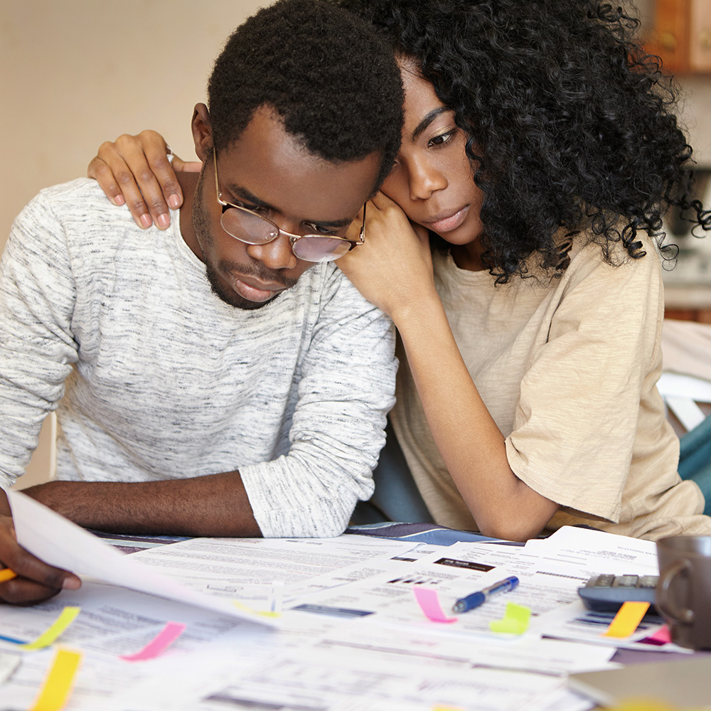 Concerned couple looking at bills and paperwork