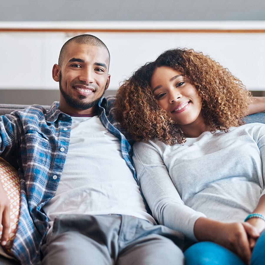 happy couple sitting on a couch