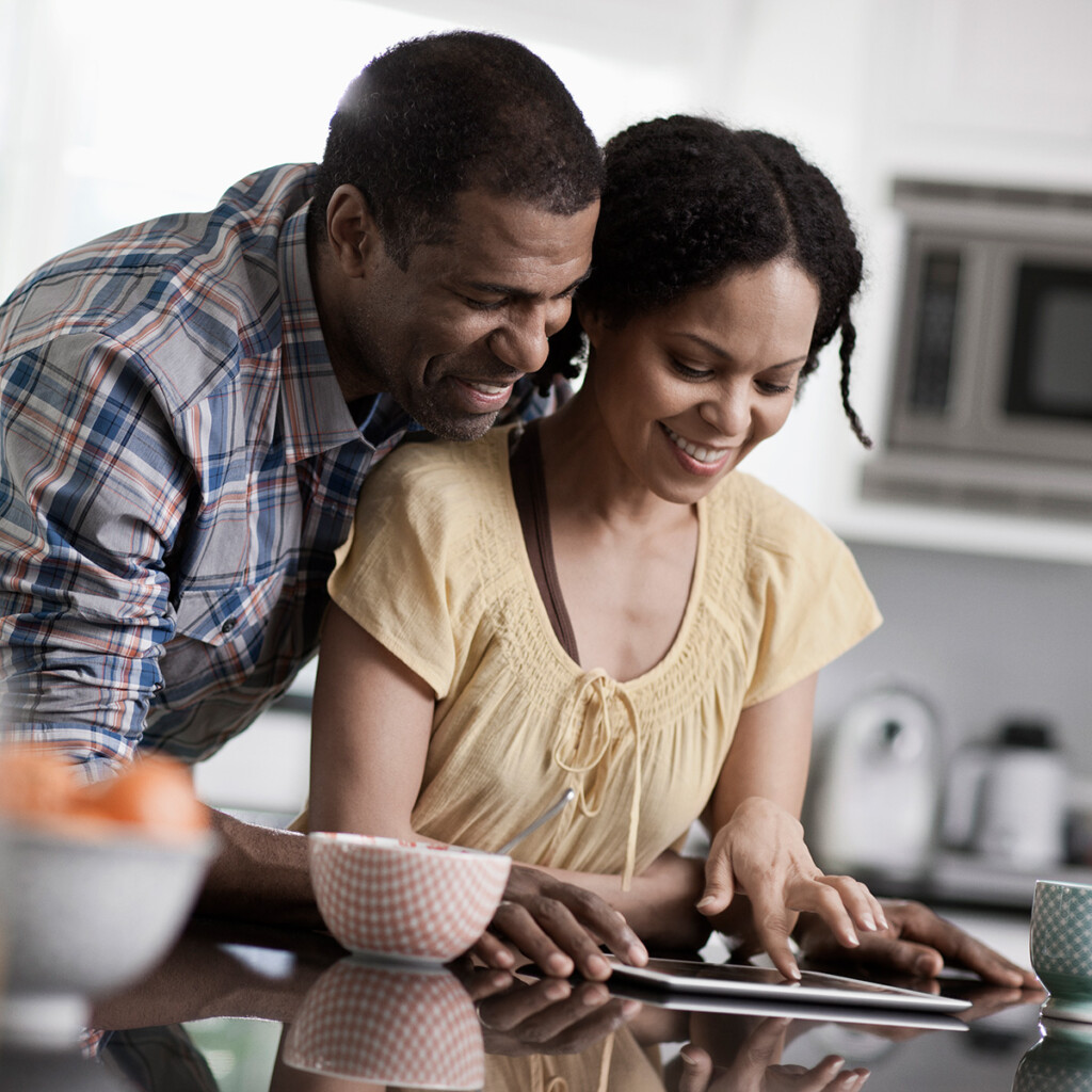 confident couple looking at tablet