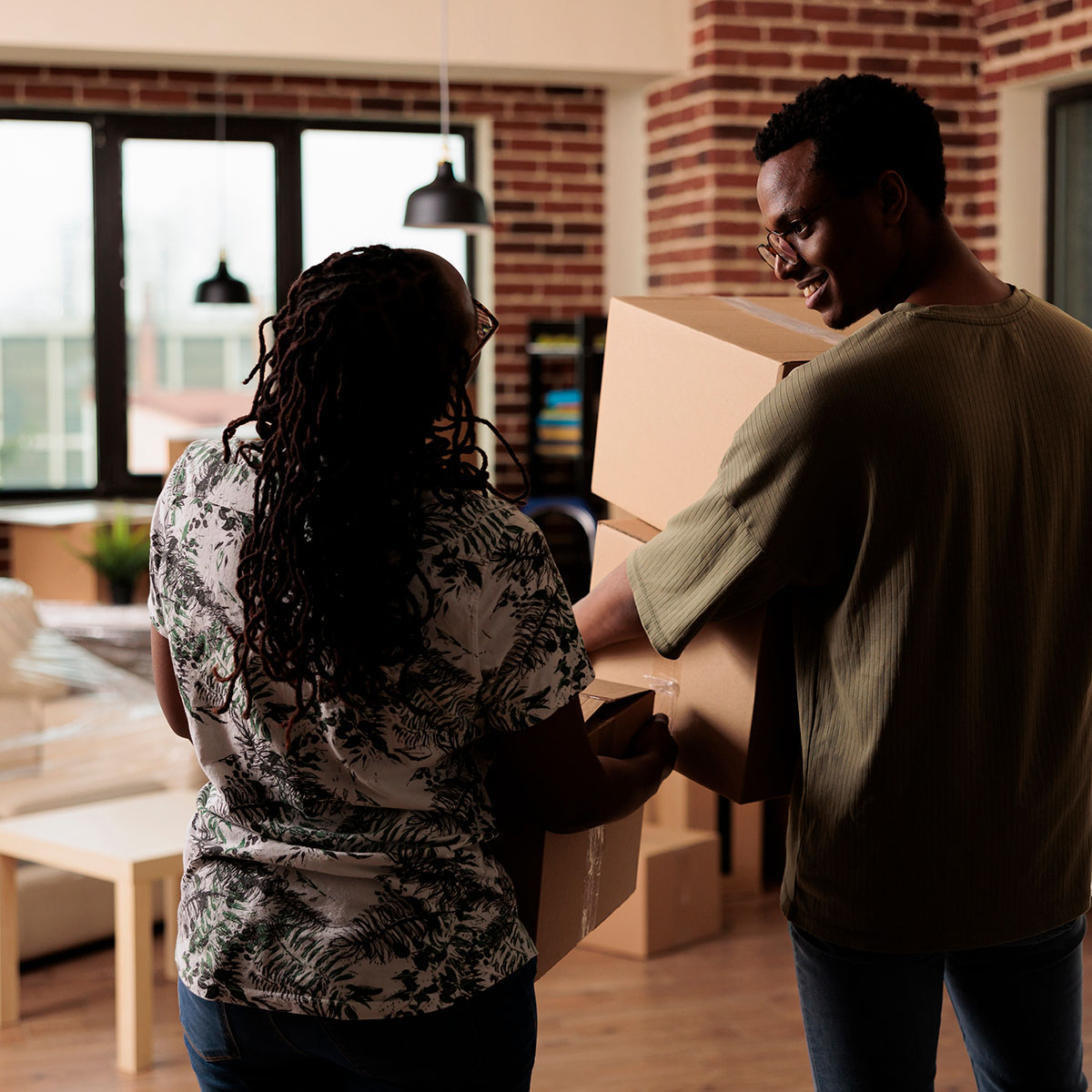 couple with boxes moving in to their new home