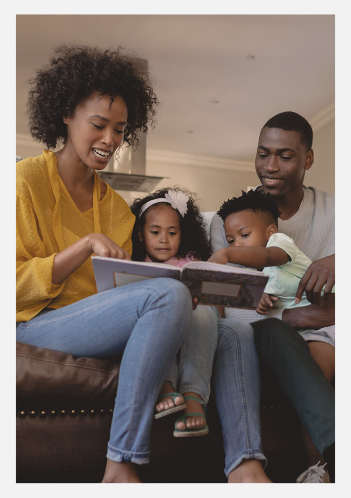a mom reading to her two young children with dad reading along