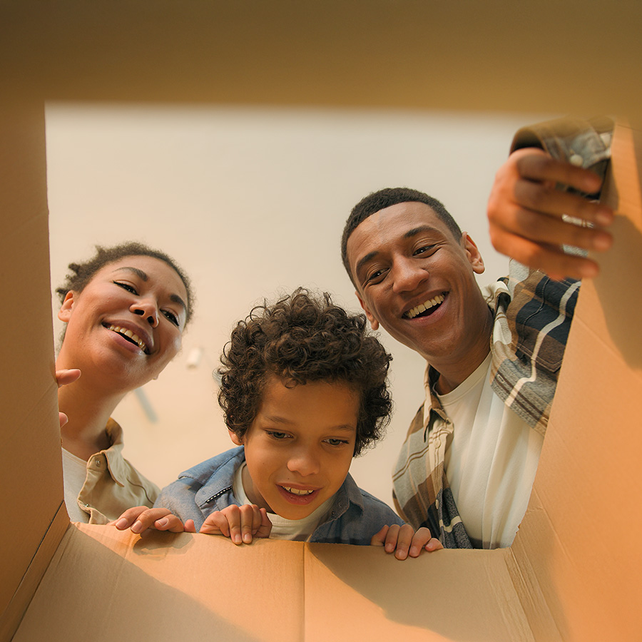 happy family looking into a moving box