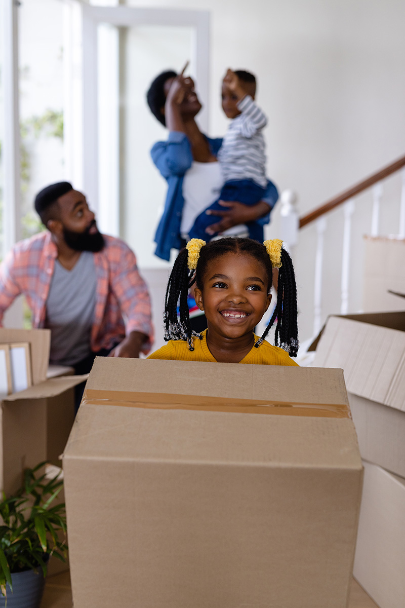 happy family holding boxes on moving day