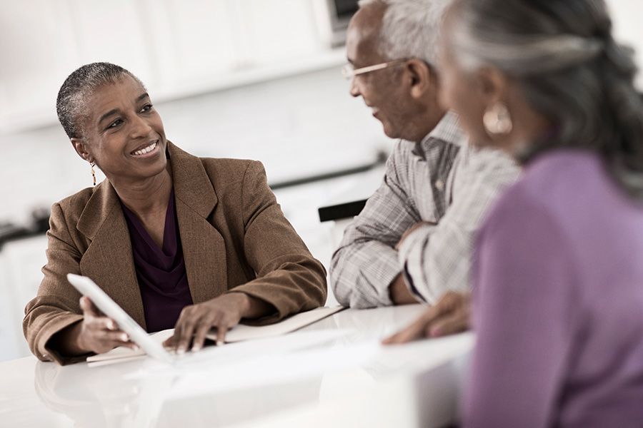 three people discussing financial matters at a table