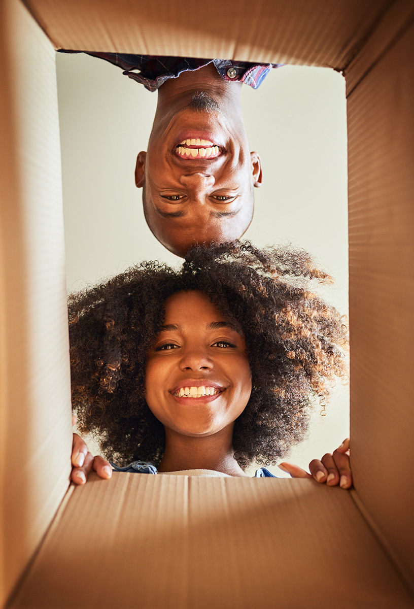 two happy people looking into a box